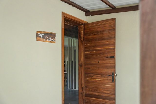 The wooden entrance door with the L'Albizia name sign