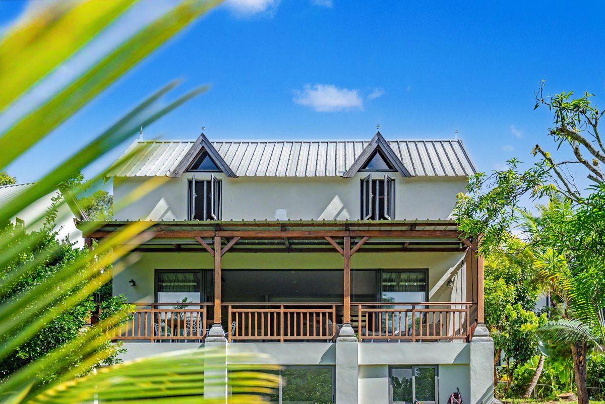 The front of L'Albizia with its dormer windows and shaded veranda