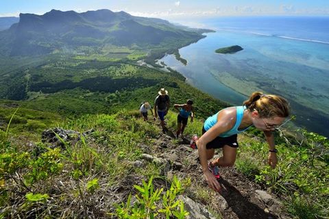 Hikers climbing Le Morne Brabant with the turquoise lagoon far below