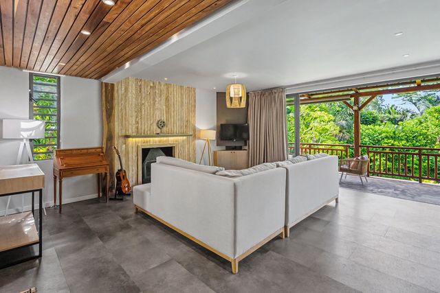 Open living space with timber ceiling and piano