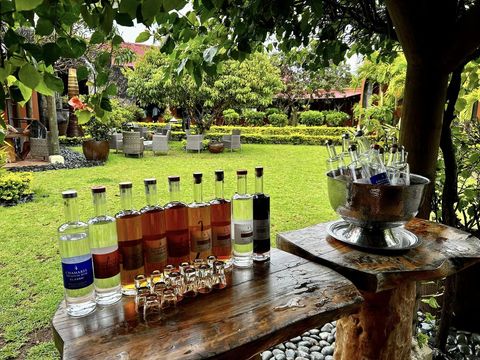 Rum tasting bottles lined up in the gardens of the Rhumerie de Chamarel